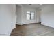 Bright and airy living area with wood-look floors and a window at 10010 S 37Th Ave, Laveen, AZ 85339