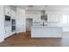Spacious kitchen with white cabinets, large island, and stainless steel appliances at 10010 S 37Th Ave, Laveen, AZ 85339