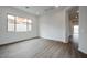 Open concept living area with wood-look floors and views to backyard at 10010 S 37Th Ave, Laveen, AZ 85339