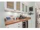 Kitchen features a built-in coffee bar with wine cooler and wood countertop at 2526 W Wethersfield Rd, Phoenix, AZ 85029