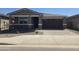 One-story home with gray exterior, two-car garage, and landscaped front yard at 40475 W Wade Dr, Maricopa, AZ 85138