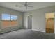 Main bedroom with carpet and large window at 22378 W Gamble Ln, Wittmann, AZ 85361