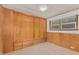 Bedroom with wood paneling, built-in drawers and a window at 8125 E Billings St, Mesa, AZ 85207