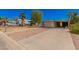Tan single-wide mobile home with carport and a small front yard at 8125 E Billings St, Mesa, AZ 85207