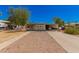 Tan single-wide mobile home with carport and small front yard at 8125 E Billings St, Mesa, AZ 85207