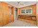 Bright bedroom featuring built-in shelving and a ceiling fan at 8125 E Billings St, Mesa, AZ 85207