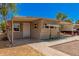 Tan single-wide mobile home with carport and small front yard at 8125 E Billings St, Mesa, AZ 85207