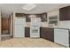 Bright kitchen with white appliances and dark brown cabinets at 8125 E Billings St, Mesa, AZ 85207