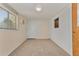Versatile spare bedroom with an exterior door and window at 8125 E Billings St, Mesa, AZ 85207