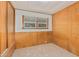 Bedroom with wood paneling, built-in drawers and a window at 8125 E Billings St, Mesa, AZ 85207