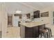 Kitchen features an island, stainless steel appliances, and dark brown cabinets at 8125 E Billings St, Mesa, AZ 85207