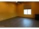 Spacious bedroom with dark wood floors and large window at 19132 W Townley Ct, Waddell, AZ 85355