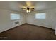Spacious bedroom with two windows and a ceiling fan at 7501 N 59Th Dr, Glendale, AZ 85301