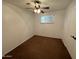Simple bedroom with ceiling fan and brown carpet at 7501 N 59Th Dr, Glendale, AZ 85301