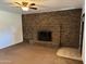 Living room featuring a brick fireplace and ceiling fan at 7501 N 59Th Dr, Glendale, AZ 85301