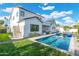Expansive pool area with a view of the home's exterior, including a luxurious outdoor shower at 4007 E Montecito Ave, Phoenix, AZ 85018