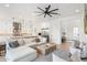 Open living room with white sectional sofa, wood coffee table, and kitchen views at 4007 E Montecito Ave, Phoenix, AZ 85018