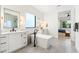 Bright bathroom with double vanity, freestanding tub, and bedroom view at 4007 E Montecito Ave, Phoenix, AZ 85018