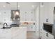 Modern kitchen with white cabinets, quartz countertops, and stainless steel appliances at 4007 E Montecito Ave, Phoenix, AZ 85018