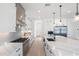 Modern white kitchen with marble countertops and stainless steel appliances at 4007 E Montecito Ave, Phoenix, AZ 85018