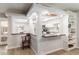 Open kitchen with breakfast bar, white cabinets, and dark countertops at 4525 N 66Th St # 70, Scottsdale, AZ 85251