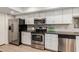 Modern kitchen with stainless steel appliances and white shaker cabinets at 4525 N 66Th St # 70, Scottsdale, AZ 85251