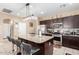 Modern kitchen featuring stainless steel appliances and dark wood cabinetry at 20051 N Herbert Ave, Maricopa, AZ 85138