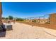 Spacious backyard with gravel, a patio, and a metal fence at 20051 N Herbert Ave, Maricopa, AZ 85138