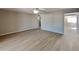 Open living room with wood-look flooring, leading to dining area at 5480 E Boston St, Mesa, AZ 85205
