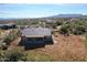 Aerial view of a house on a desert lot with mountain views at 14036 E Barbie Ln, Scottsdale, AZ 85262