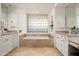 Spa-like bathroom with soaking tub and glass block window at 9975 E Broken Spur Dr, Scottsdale, AZ 85262