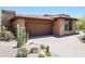 Front view of home with desert landscaping at 9975 E Broken Spur Dr, Scottsdale, AZ 85262