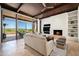 Open concept living room with fireplace, large windows, and mountain views at 9975 E Broken Spur Dr, Scottsdale, AZ 85262