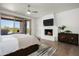 Bright bedroom with fireplace, hardwood floors and patio access at 9975 E Broken Spur Dr, Scottsdale, AZ 85262