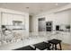 Modern kitchen with white cabinets, granite counters, and stainless steel appliances at 9975 E Broken Spur Dr, Scottsdale, AZ 85262