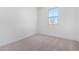 Bright bedroom with neutral carpeting and a window with a view at 16911 W Siesta Way, Goodyear, AZ 85338