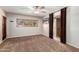 Spacious bedroom with carpet, ceiling fan, and access to bathroom at 5540 E Dahlia Dr, Scottsdale, AZ 85254