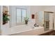 Relaxing bathroom with soaking tub, walk-in shower, and updated finishes at 9768 E Balancing Rock Rd, Scottsdale, AZ 85262