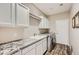 Laundry room with built-in cabinets and granite countertop at 9768 E Balancing Rock Rd, Scottsdale, AZ 85262