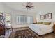 Bright bedroom with a king-size bed, plantation shutters, and ceiling fan at 9768 E Balancing Rock Rd, Scottsdale, AZ 85262