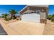 White garage door and stone accents on a tan house at 2550 S Ellsworth Rd # 366, Mesa, AZ 85209