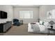 Main bedroom with a king-size bed, armchair, and neutral decor at 1973 W Brooke Ln, Queen Creek, AZ 85144