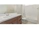 Clean bathroom with brown vanity, white countertop and bathtub at 1973 W Brooke Ln, Queen Creek, AZ 85144