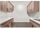 Laundry room with shaker cabinets and hexagon tile floor at 1973 W Brooke Ln, Queen Creek, AZ 85144