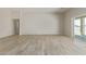Bright and airy living room with large windows and wood-look floors at 1973 W Brooke Ln, Queen Creek, AZ 85144