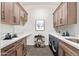 Laundry room with modern cabinets, washer, dryer, and a sink at 1973 W Brooke Ln, Queen Creek, AZ 85144