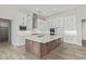 Modern kitchen with white shaker cabinets, herringbone backsplash and large island at 1973 W Brooke Ln, Queen Creek, AZ 85144
