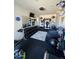 Well-equipped home gym featuring mirrors and fans at 1973 W Brooke Ln, Queen Creek, AZ 85144