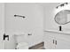 Modern bathroom with white cabinets, quartz countertop, and black fixtures at 1873 E Ellis Dr, Tempe, AZ 85282