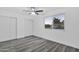 Bright bedroom with ceiling fan, double closets and gray vinyl plank flooring at 1873 E Ellis Dr, Tempe, AZ 85282